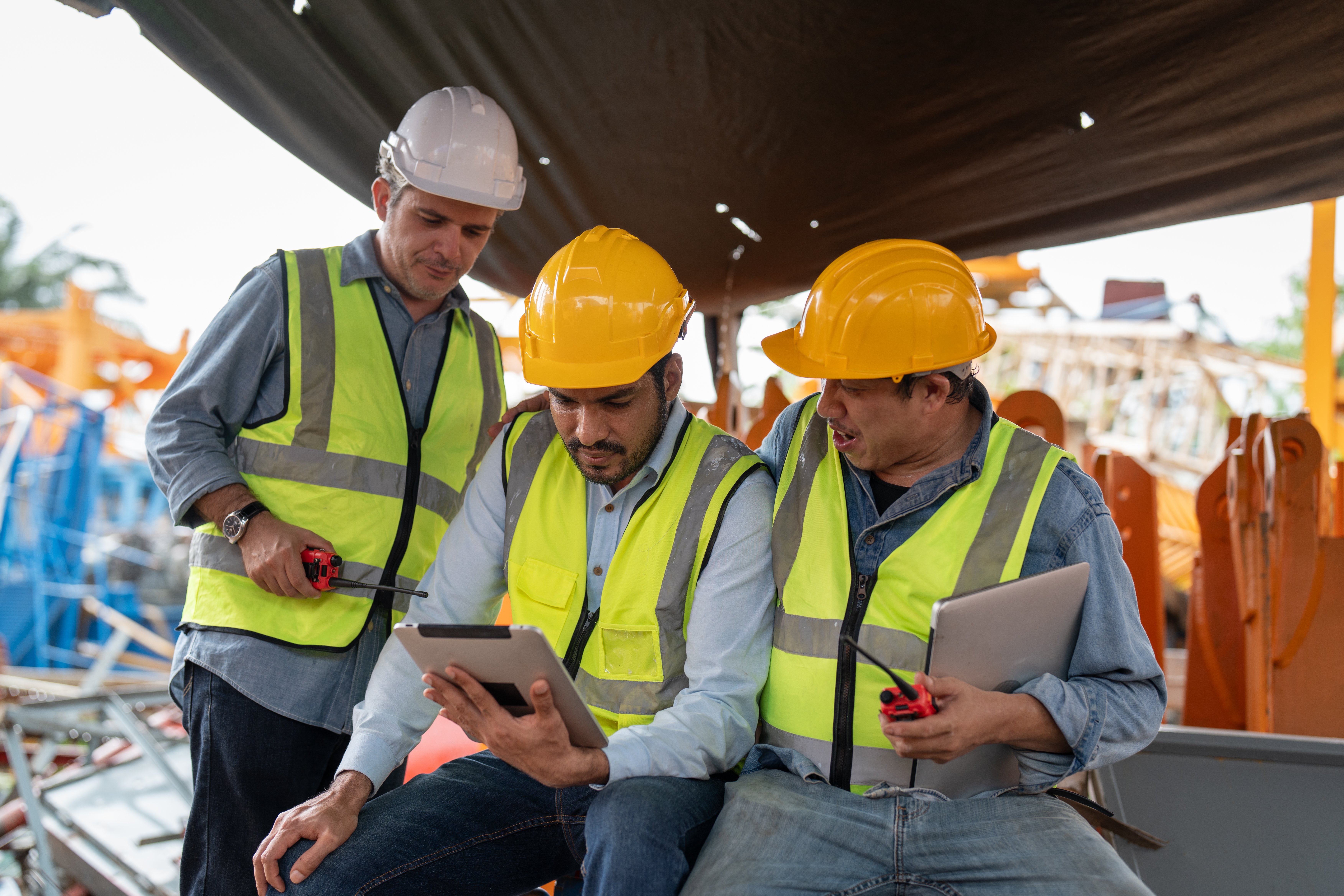 Construction team reviewing plans on tablet